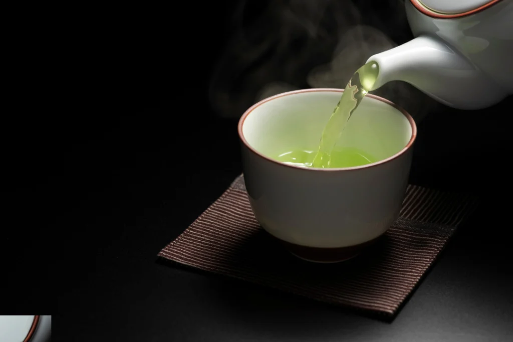 Green tea cup on the black table