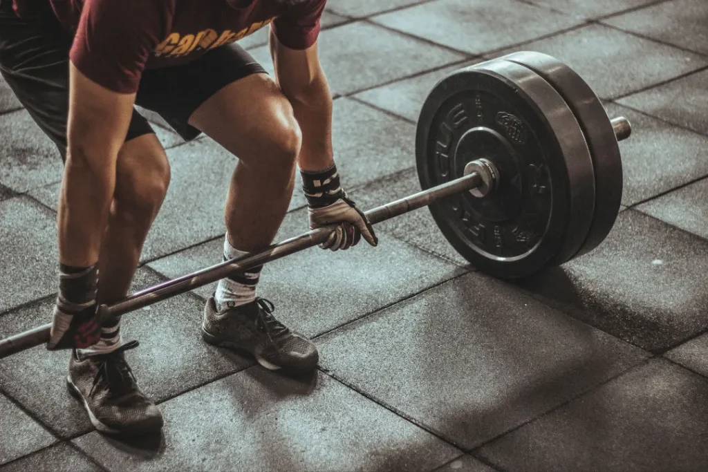 the person holding a black silver barbell