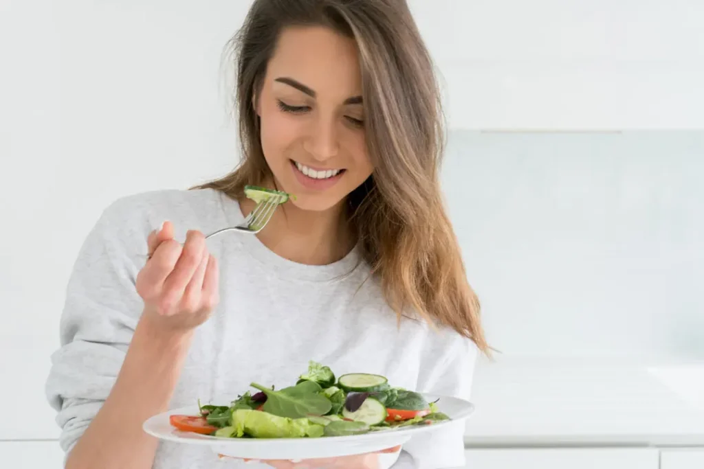 A girl eating salad.