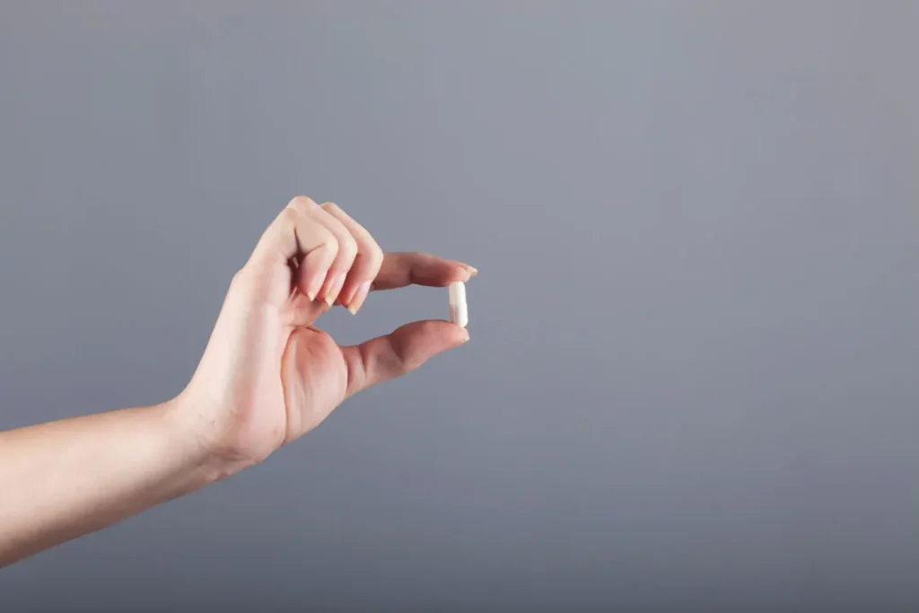 woman holding SelenoExcell® pill