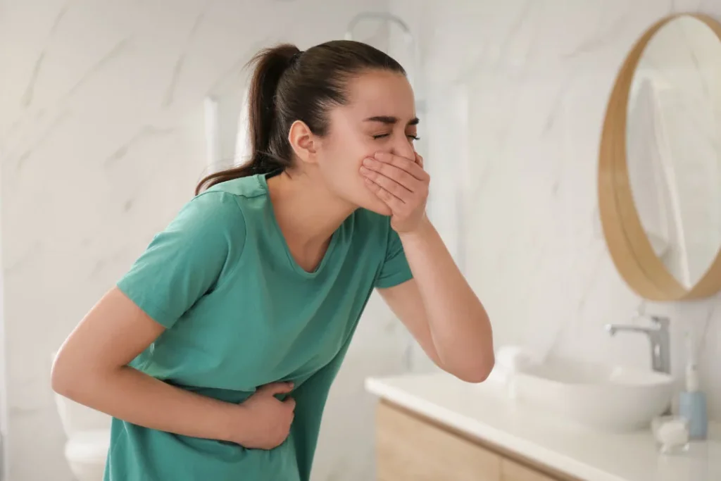 A young girl having vomit. 