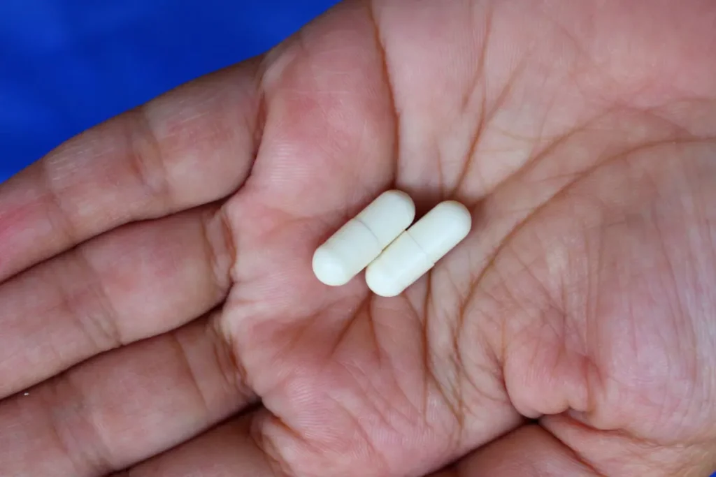 Chitosan pills on female hand'