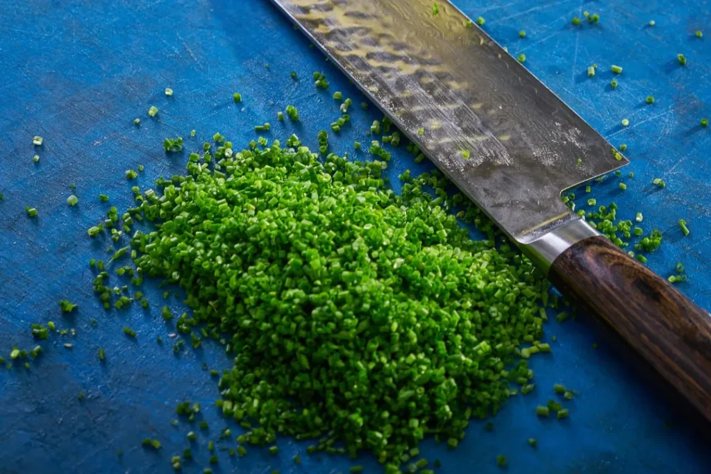 cutting chives in kitchen