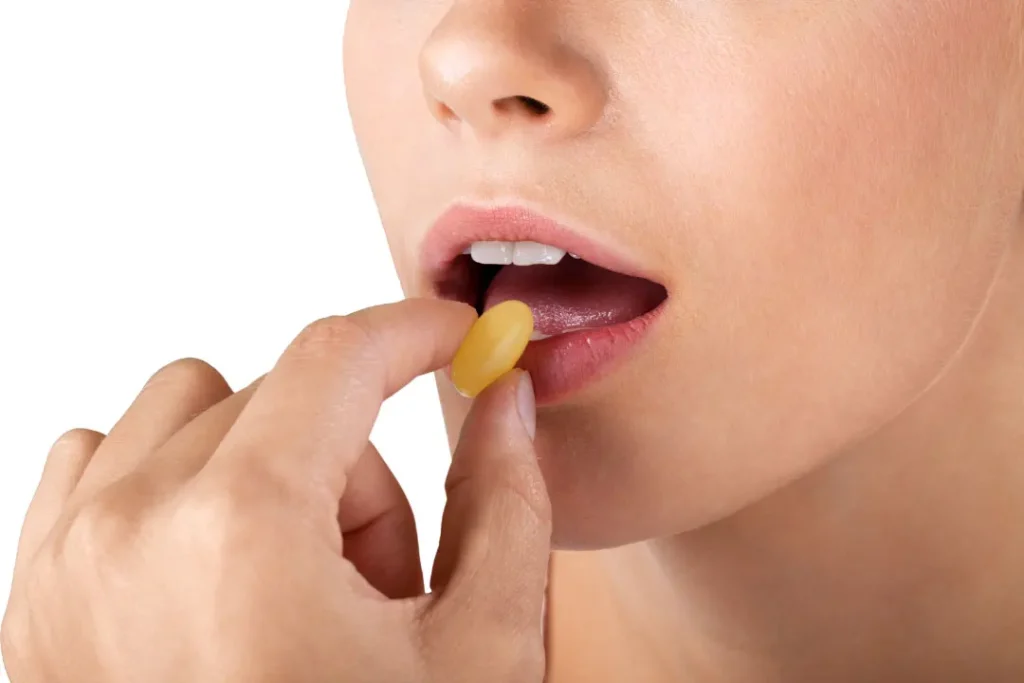 A lady eating supplement. 