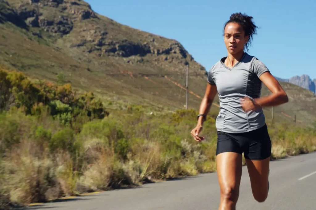 A lady is running on road. 