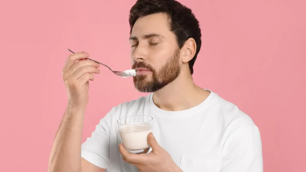 Man is eating Yogurt