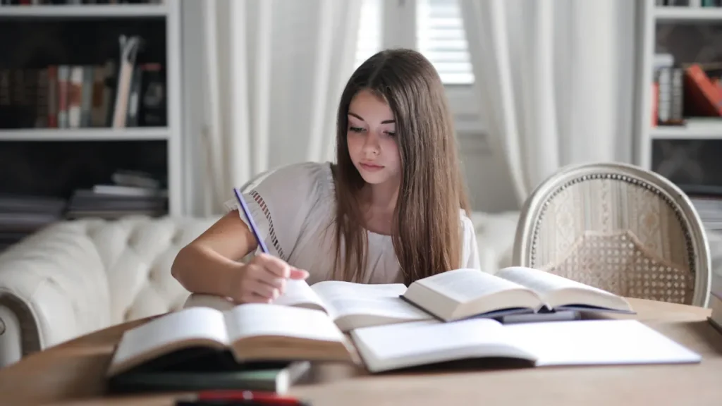 Young girl is reading book. 