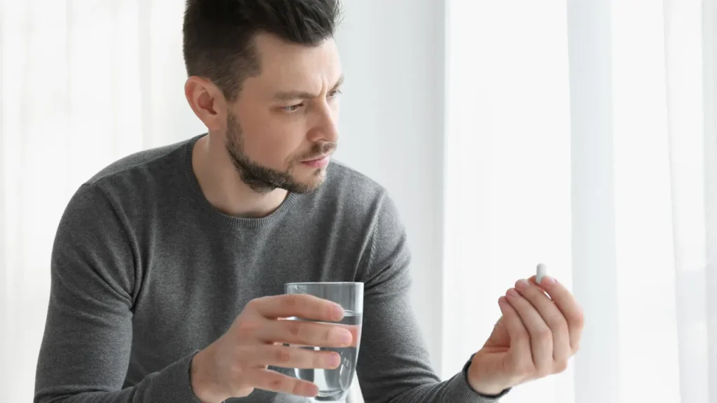 Man having supplement. 