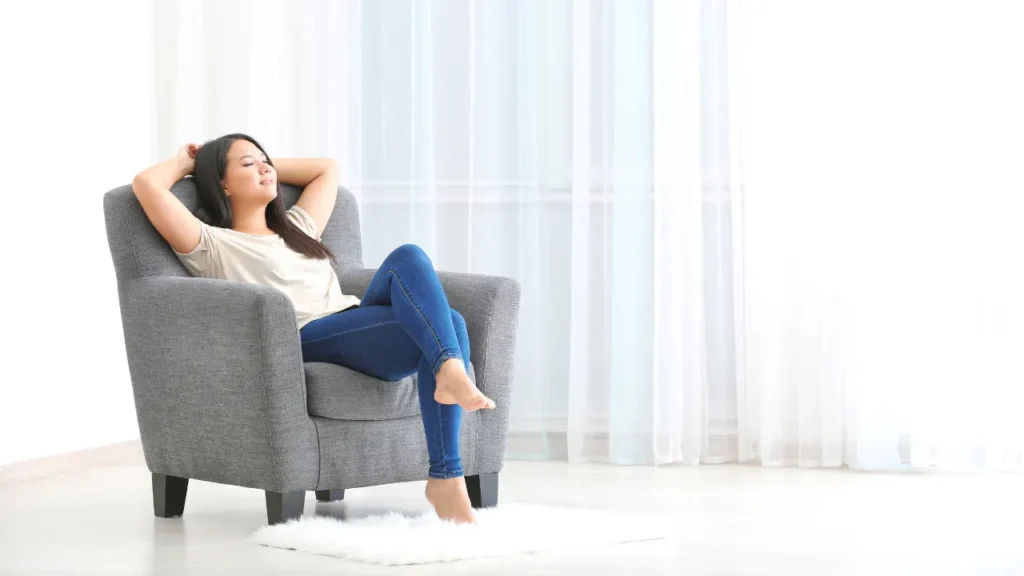 Lady is sitting on sofa. 