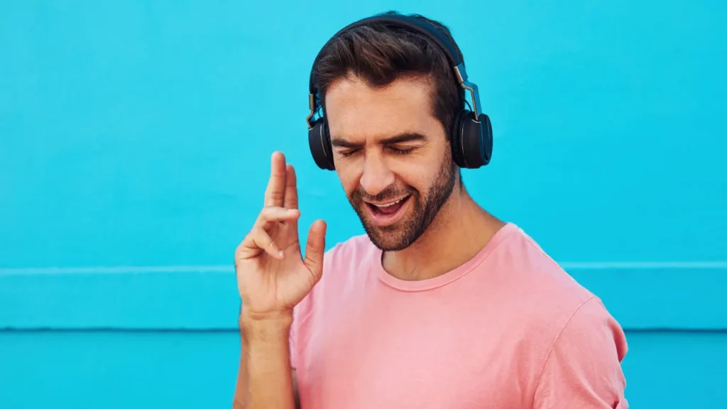 Young man is listening music.  