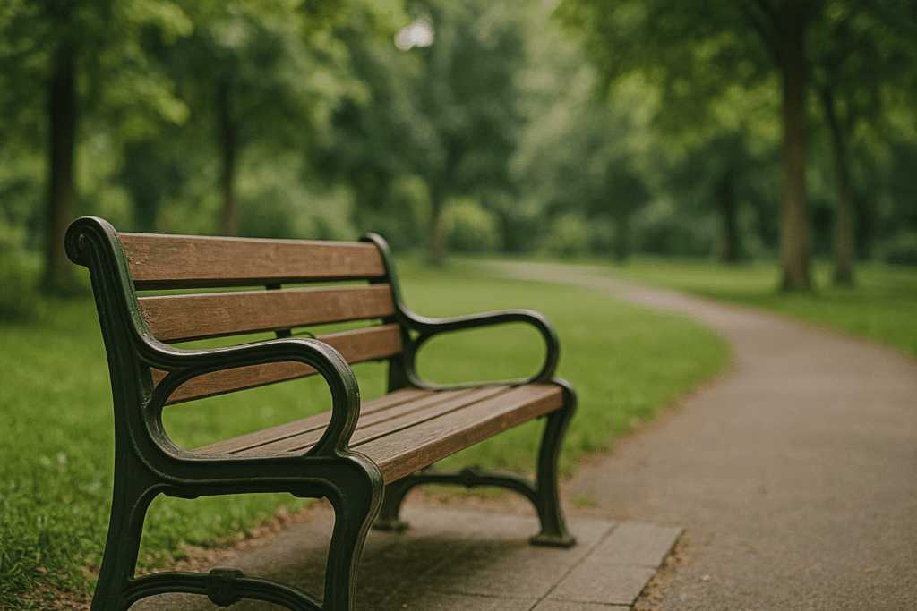A quiet park bench surrounded by greenery and dappled sunlight, reflecting how nature and outdoor environments support mental wakefulness naturally.